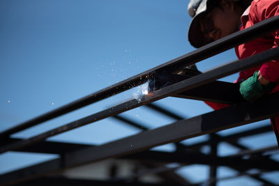 Full length of boy on railing against clear blue sky