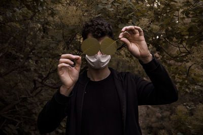 Full length portrait of man holding plants