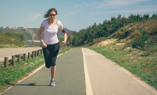 Full length of woman running on road