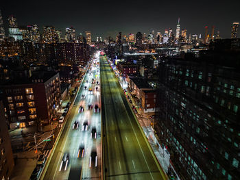 Motion blurred aerial shot of traffic on busy multilane expressway in night metropolis. downtown
