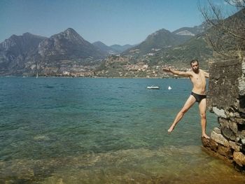 Portrait of shirtless man standing over sea