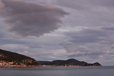 Scenic view of sea and mountains against sky