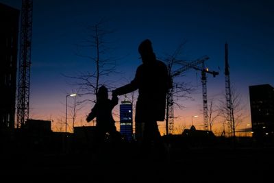 Low angle view of silhouette people against sky