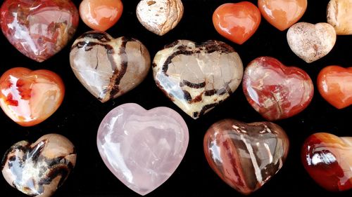 Close-up of heart shaped gemstones over black background