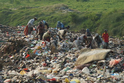 Group of people working on garbage