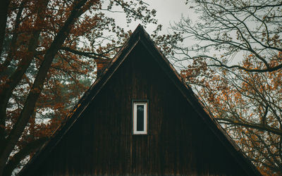 Low angle view of trees and house in forest