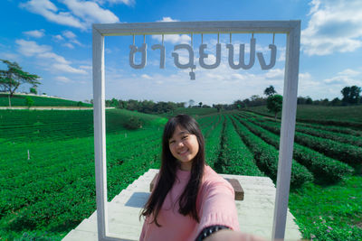 Portrait of smiling young woman on field