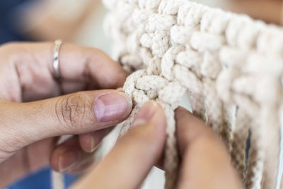 Close-up of woman knitting rope