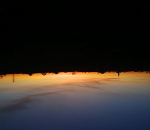 Scenic view of lake against sky at night