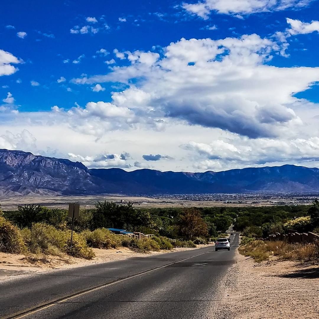 ROAD BY LANDSCAPE AGAINST BLUE SKY