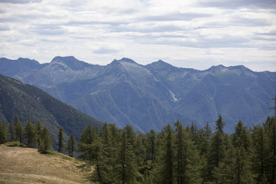 Scenic view of mountains against cloudy sky