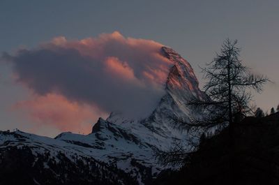 Scenic view of snowcapped mountains against sky during sunset