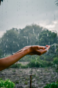 Close-up of hand on wet glass