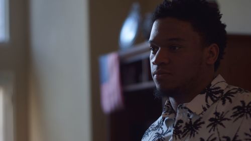 Portrait of young man looking away at home