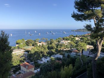 High angle view of buildings by sea against sky