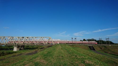 Bridge over landscape against blue sky