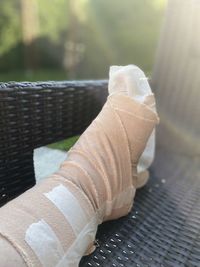 Close-up of broken leg on chair