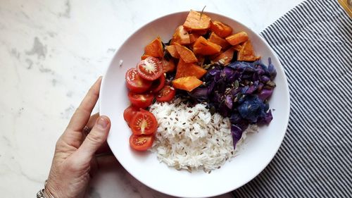 High angle view of person holding food on table