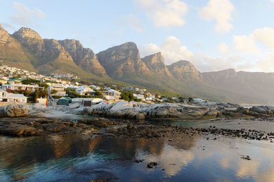 Scenic view of sea by buildings against sky