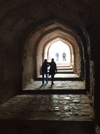 Rear view of silhouette people in corridor of building