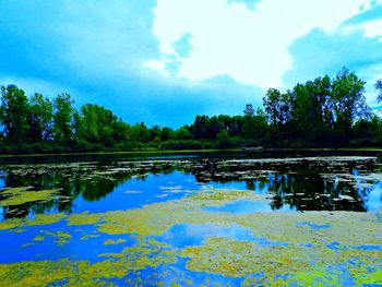 Scenic view of lake against cloudy sky