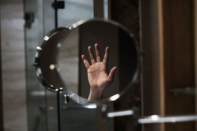 Midsection of man hand on glass