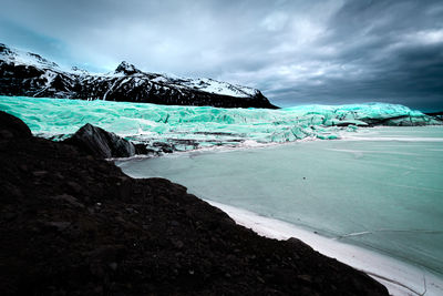 Icelandic glacier with basaltic surrounding and snow for a beautiful contrast