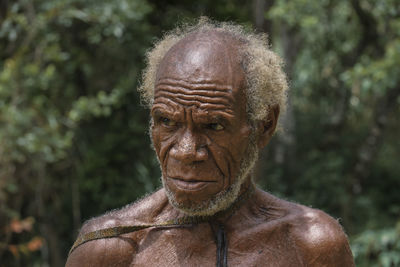 Close-up portrait of shirtless man