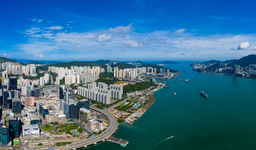 Aerial view of sea and buildings against sky