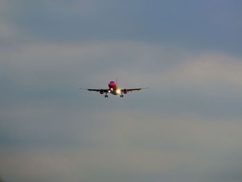 Low angle view of airplane flying in sky