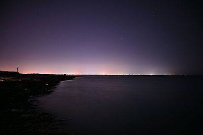 Scenic view of sea against sky at night