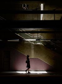 Full length of woman standing on staircase