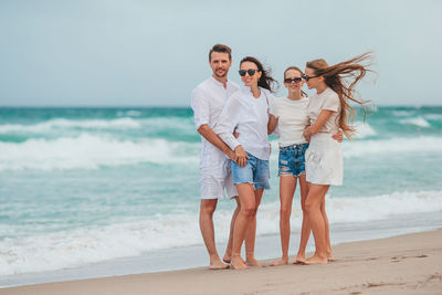 Friends standing at beach