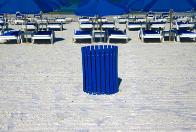 View of blue chairs on beach