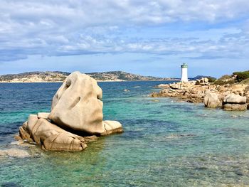 Rocks on sea shore against sky