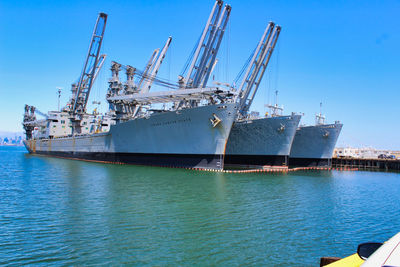 Commercial dock by sea against blue sky