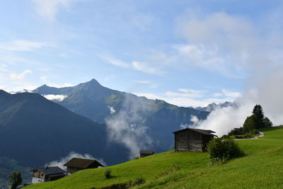 Houses on field against sky