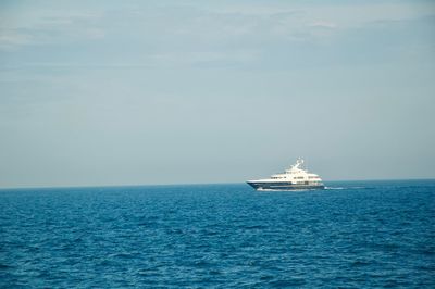 Ship sailing in sea against sky