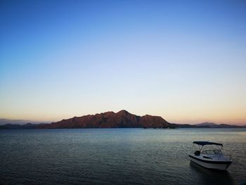 Scenic view of sea against clear sky during sunset