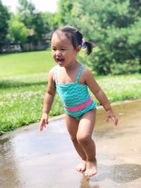 Full length of cute girl standing at park