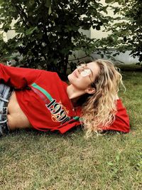 Young woman lying down on field