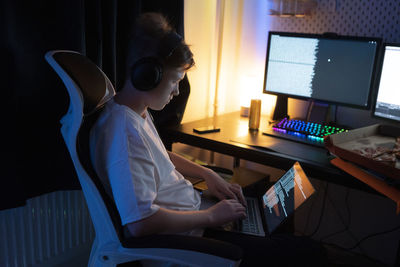 Boy using laptop at home