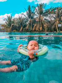 Full length of boy swimming in pool