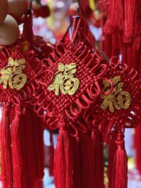 Close-up of red decoration hanging against blurred background