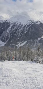 Scenic view of snow covered land against sky