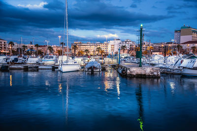 Sailboats moored in harbor