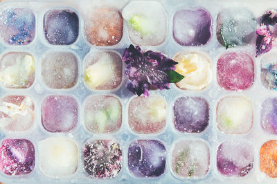 High angle view of multi colored candies in glass