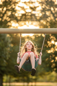 Boy swinging at playground