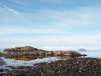 Rocks on beach against sky