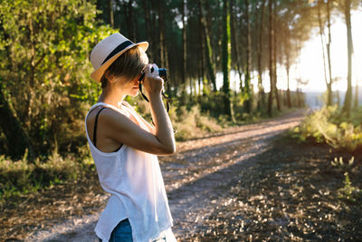 Man photographing with camera while standing on land